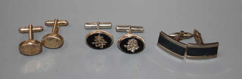 A pair of sterling cufflinks and two other pairs of cufflinks.
